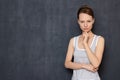 Portrait of focused serious woman touching chin with hand Royalty Free Stock Photo