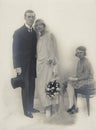 Studio wedding photograph of the marriage of a young couple around 1925 with the bridesmaid or a child from a previous marriage