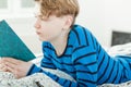 Studious young teenage boy reading a book Royalty Free Stock Photo