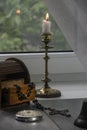 Chandelier with household items on the window, cross, women`s mirror. Royalty Free Stock Photo