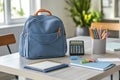 A study area featuring a backpack, calculator, notebooks, and colorful pens on a table Royalty Free Stock Photo