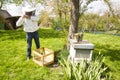 The study of bees is known as melittology. This Beekeeper is ready to check on the bee hive while wearing protective clothing