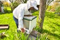 The study of bees is known as melittology. This Beekeeper is ready to check on the bee hive while wearing protective clothing