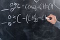 study of chemistry concept, chemist hand draws formulas and elements with chalk on the blackboard, signs and symbols of Royalty Free Stock Photo