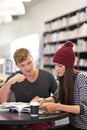 Study companions. two college students studying together at the library. Royalty Free Stock Photo