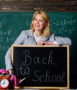 Study and education. Modern school. Knowledge day. teacher with alarm clock at blackboard. Time. Back to school Royalty Free Stock Photo