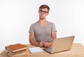 Study, education, people concept - student funny man doing exercises in netbook, looking surprised