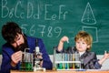 Study in educational activity through experience. Chemical invention. School laboratory. Teacher and pupil boy in Royalty Free Stock Photo