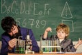 Study in educational activity through experience. Chemical invention. School laboratory. Teacher and pupil boy in Royalty Free Stock Photo