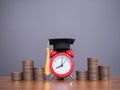 Study goals, Red alarm with graduation hat and stack of coins. The concept for Resolution, Goal, Action, Planning, and manage time Royalty Free Stock Photo