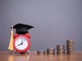 Study goals, Red alarm with graduation hat and stack of coins. The concept for Resolution, Goal, Action, Planning, and manage time Royalty Free Stock Photo