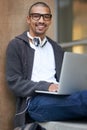 Study hard, but study smart. Portrait of a college student using his laptop while sitting outside at campus. Royalty Free Stock Photo