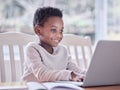 Study hard what interests you the most. a young boy doing his homework on a laptop at home. Royalty Free Stock Photo