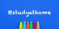 Study at home. Words or typed text on blue board. Colorful crayons. Top view