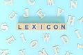 Study lexicon in linguistics concept. Wooden blocks word typography flat lay in blue background.