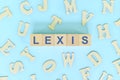 Study lexis in linguistics concept. Wooden blocks word typography flat lay in blue background.