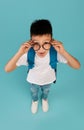 Study Offer. Funny Korean Schoolboy Wearing Eyeglasses Looking At Camera With Excitement