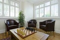 Study room with leather armchairs and chess board Royalty Free Stock Photo
