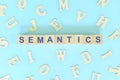 Study semantics in linguistics concept. Wooden blocks word typography flat lay in blue background.