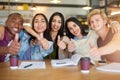 This study session is going great. Portrait of a group of happy students having a study session in a cafe. Royalty Free Stock Photo