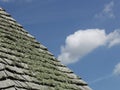 A study of a slated roof against a blue sky. Royalty Free Stock Photo