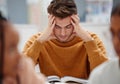 Study, stress and student at university with anxiety for a test. Young man with headache, worried and studying with Royalty Free Stock Photo