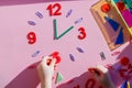 Study the topic of hours with children. The watch is made of numbers, paper clips, and sticks from a children learning kit
