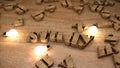 Study word from wooden cubes, wood letters text string on table with light bulbs Royalty Free Stock Photo