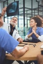 Studying the scans from multiple viewpoints. a team of doctors analysing x-rays during a meeting in a hospital. Royalty Free Stock Photo