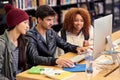 Studying the smart way. a group of students working together at a computer in a university library. Royalty Free Stock Photo