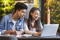 Studying students looking at laptop and smiling Royalty Free Stock Photo