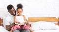 African father reading with his adorable little daughter at home Royalty Free Stock Photo