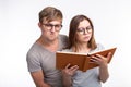 Studying together and people concept - a couple of young funny people reading a book