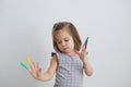 Stuff dancer.little girl playing with felt tip pens. baby girl painting and playing. colorful stuff felt pen caps on fingers Royalty Free Stock Photo