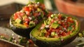 Stuffed avocado halves with diced vegetables on a ceramic plate