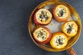 Stuffed baked apples with sezame seeds and walnuts In metal frying pan over black stone slate background Royalty Free Stock Photo