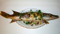 Stuffed baked pike fish with golden crust