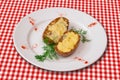 Stuffed baked potatoes with cheese served with green vegetables Royalty Free Stock Photo