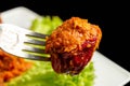 Stuffed bell peppers with meat, rice and tomato sauce on a fork, close-up Royalty Free Stock Photo