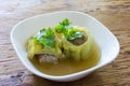 Stuffed bitter gourd soup with seasoned minced pork on wood background