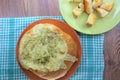 Stuffed bread with the chicken and melted cheese on the orange plate and red, brown background Royalty Free Stock Photo