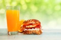 Stuffed bun with orange juice on the table, Chrono diet concept