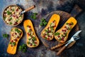 Stuffed butternut squash with chickpeas, cranberries, quinoa cooked in nutmeg, cloves, cinnamon. Thanksgiving dinner recipe.