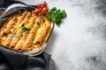 Stuffed cannelloni with bechamel sauce. Pasta baked with beef meat, cream sauce, cheese. Gray background. top view. Copy space Royalty Free Stock Photo