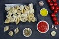 Stuffed conchiglie preparation, creamy ricotta and tomatoes sauce, top view Royalty Free Stock Photo