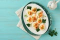 Stuffed or deviled eggs with paprika and parsley on blue plate for easter table. Traditional dish for Easter. Healthy diet food Royalty Free Stock Photo