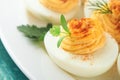 Stuffed or deviled eggs with paprika and parsley on blue plate for easter table. Traditional dish for Easter. Healthy diet Royalty Free Stock Photo