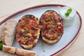 Stuffed Eggplant halves with tomato onion sweet pepper and cheese. Royalty Free Stock Photo