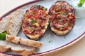 Stuffed Eggplant halves with tomato onion sweet pepper and cheese. Royalty Free Stock Photo