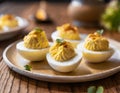 Stuffed eggs, deviled eggs on a small platter, on a wooden table, blurred background Royalty Free Stock Photo